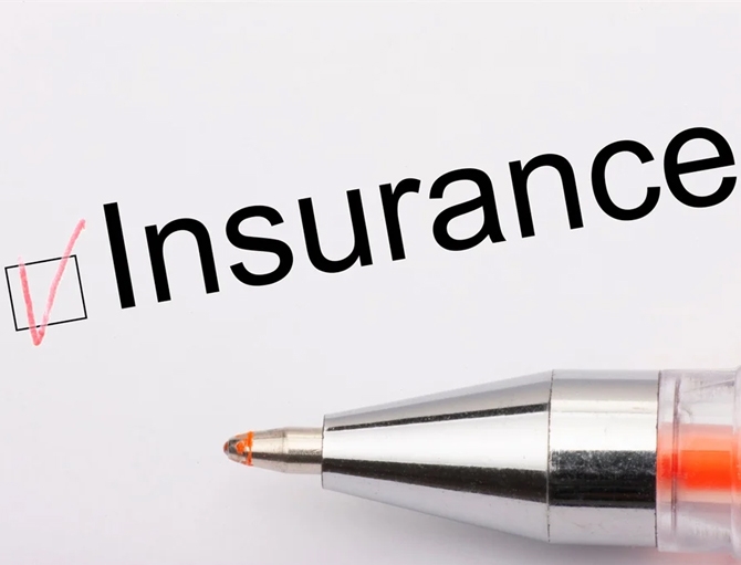 A pen and an insurance checkbox with a red tick